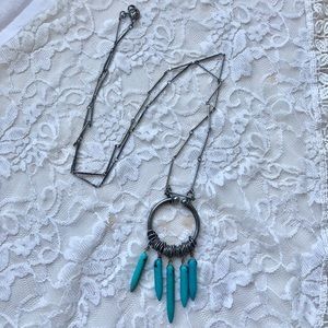 Long silver necklace with teal design